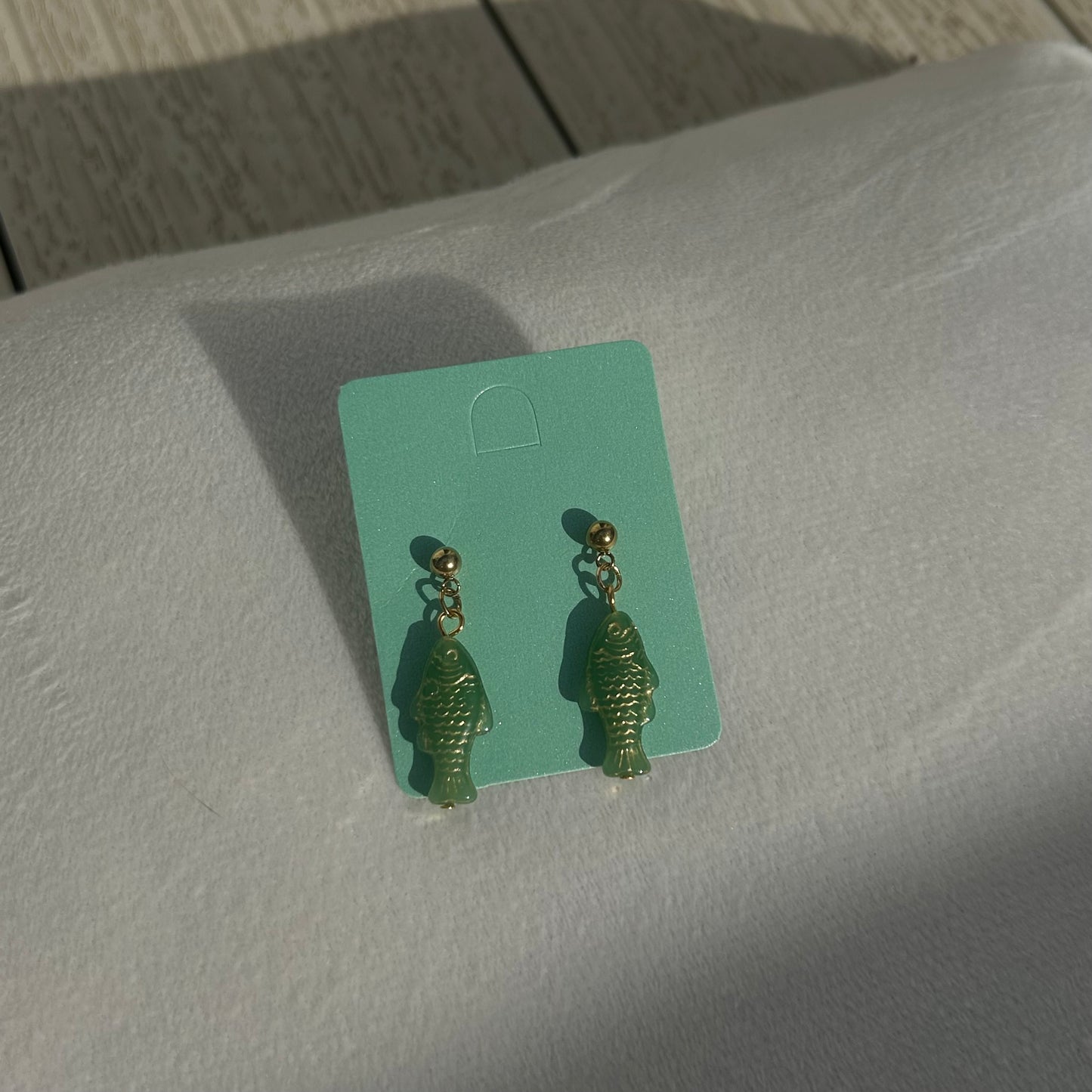 Gold on green fish studs