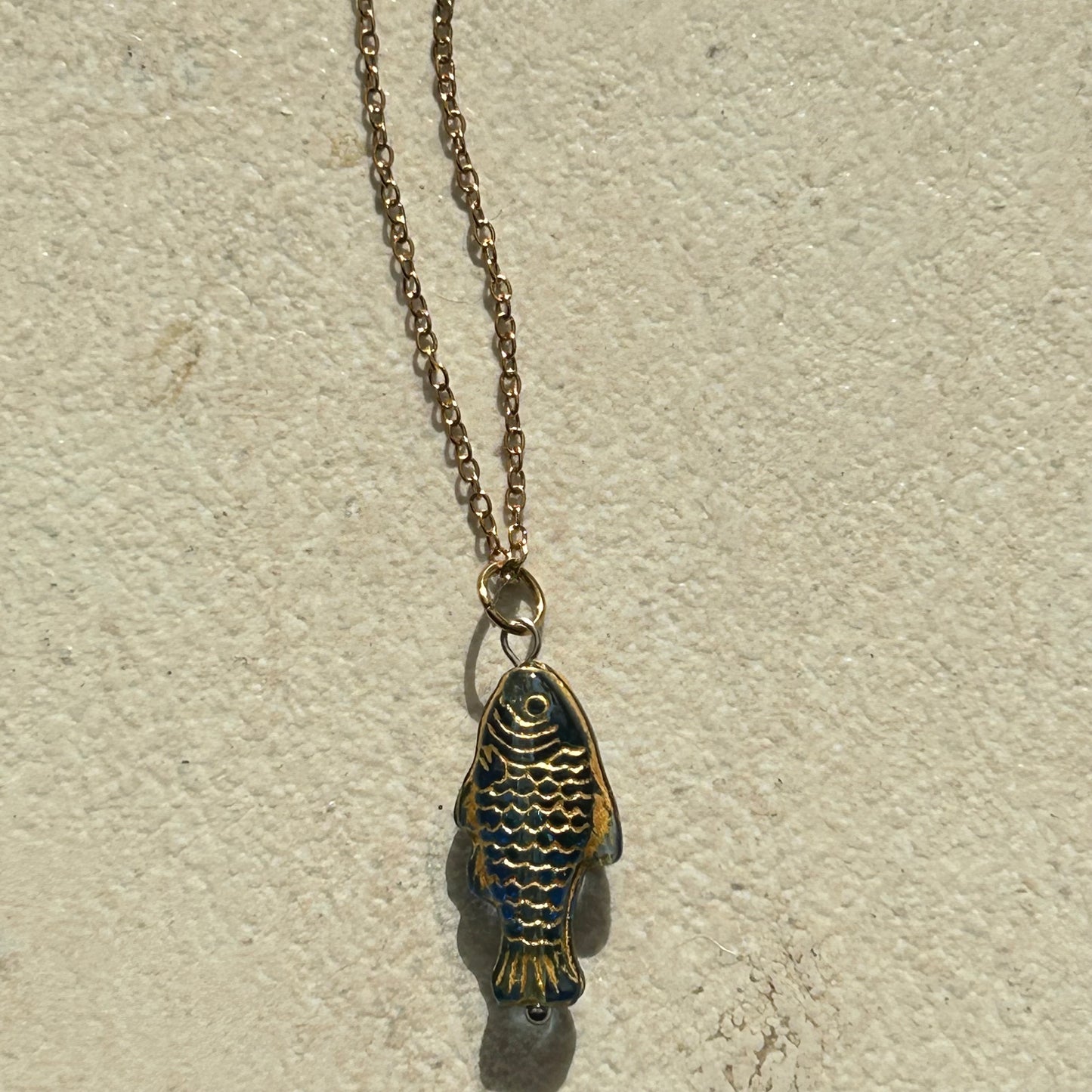 Gold on dark blue fish necklace