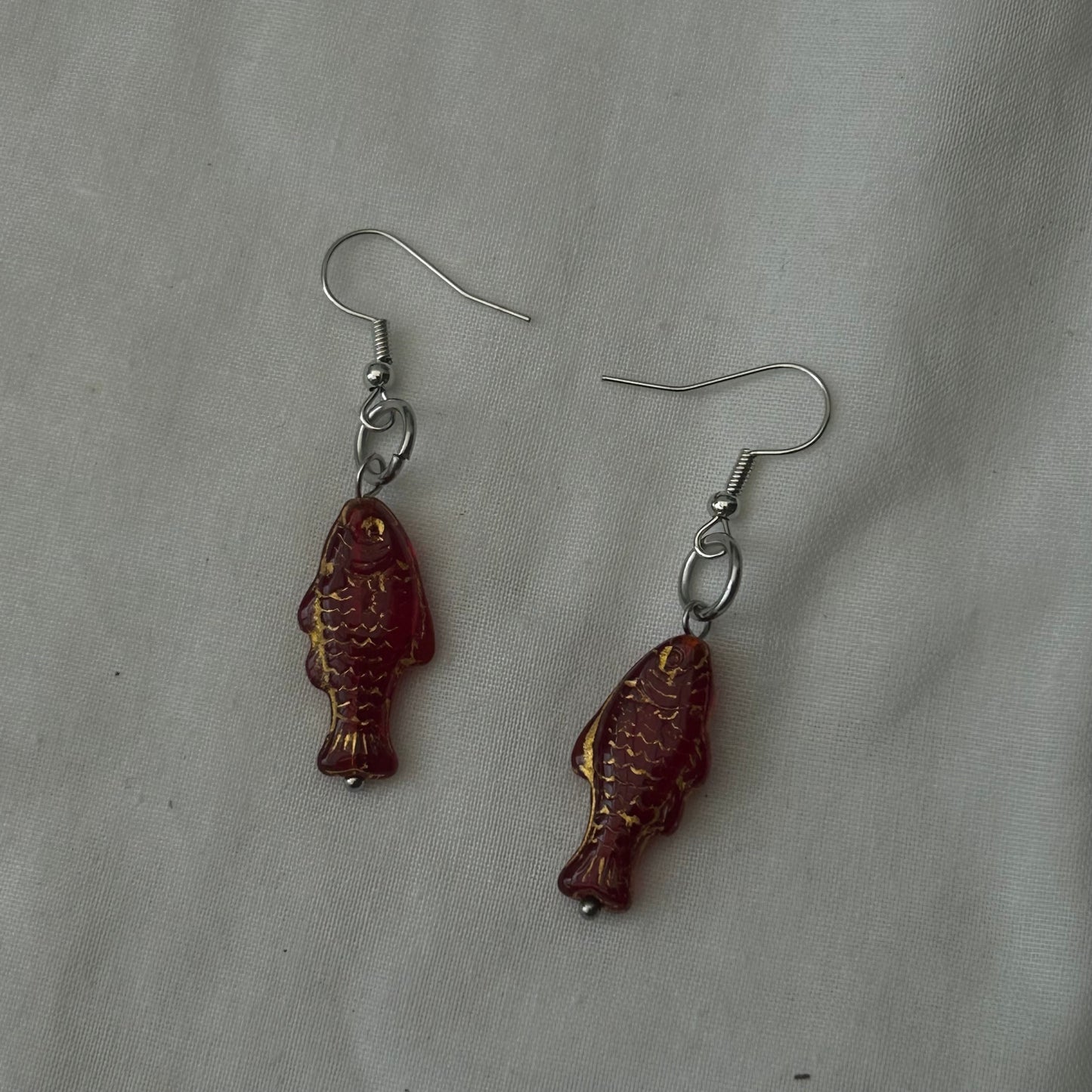 Gold on red fish earrings
