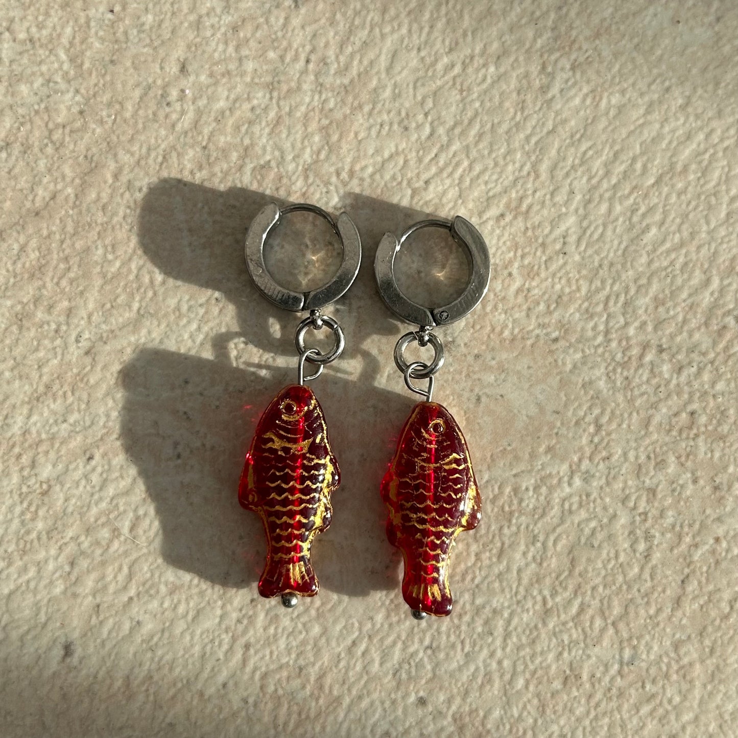 gold on red fish earrings
