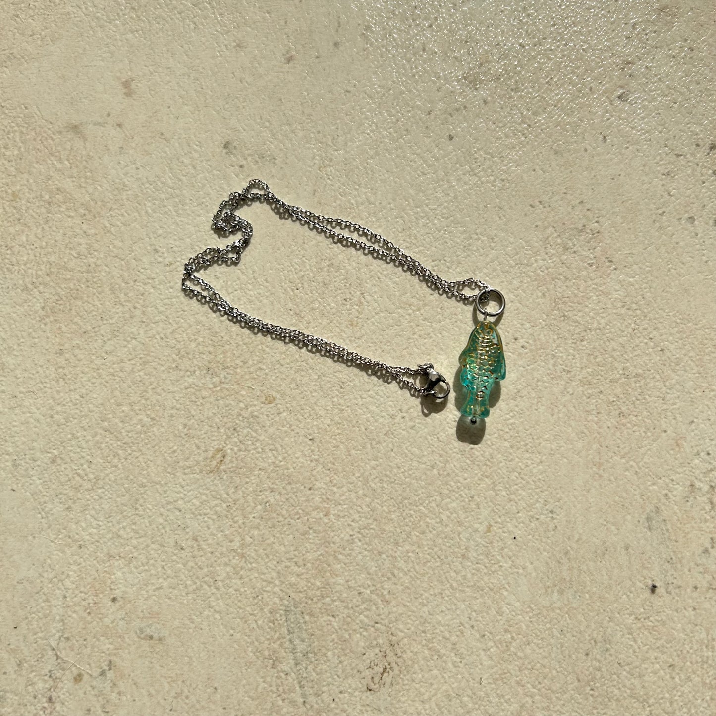 Transparent blue and gold fish necklace