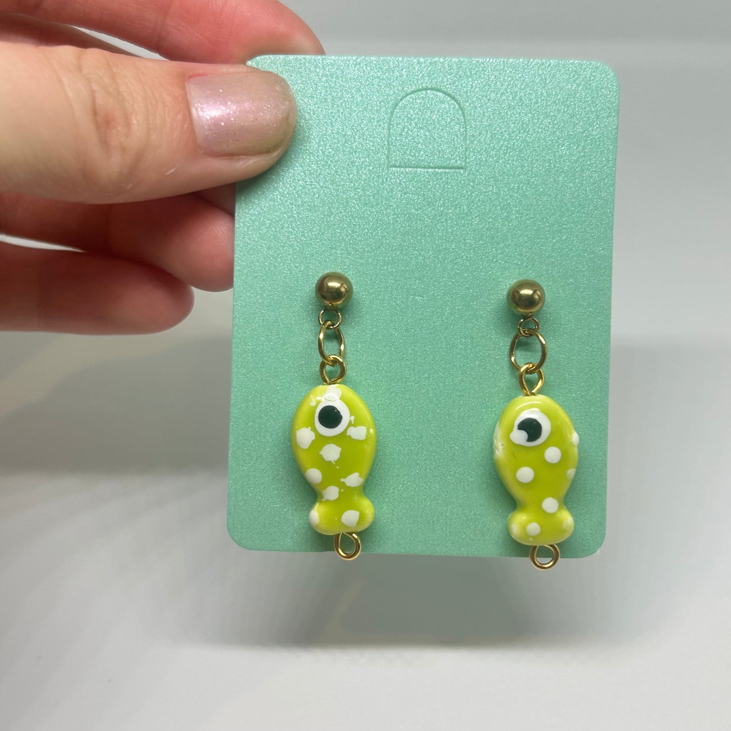 Lime green polka dot fish earrings