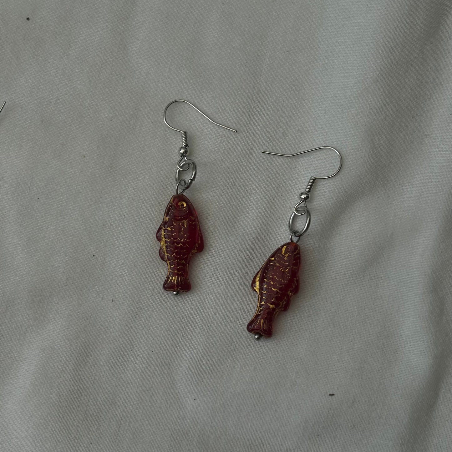 Gold on red fish earrings
